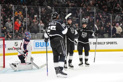 Feb 20, 2024; Los Angeles, California, USA; LA Kings center Pierre-Luc Dubois (80) celebrates after scoring a goal with right wing Quinton Byfield (55) and center Alex Turcotte (38) as Columbus Blue Jackets goaltender Elvis Merzlikins (90) reacts  in the second period at Crypto.com Arena. Mandatory Credit: Kirby Lee-USA TODAY Sports