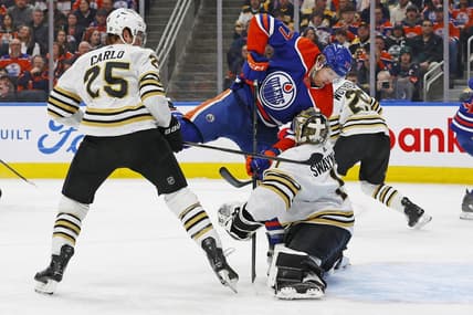 Feb 21, 2024; Edmonton, Alberta, CAN; Edmonton Oilers forward Warren Foegele (37) crashes into Boston Bruins goaltender Jeremy Swayman (1) during the first period at Rogers Place. Mandatory Credit: Perry Nelson-USA TODAY Sports