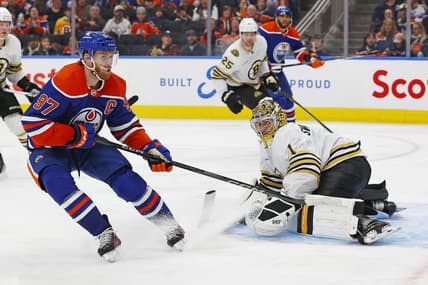 Feb 21, 2024; Edmonton, Alberta, CAN; Boston Bruins goaltender Jeremy Swayman (1) makes a save on  on Edmonton Oilers forward Connor McDavid (97) during the third period at Rogers Place. Mandatory Credit: Perry Nelson-USA TODAY Sports