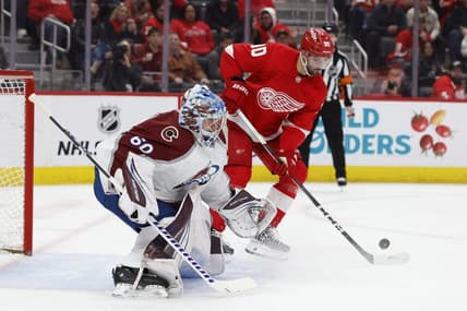 Feb 22, 2024; Detroit, Michigan, USA;  Detroit Red Wings center Joe Veleno (90) tries to score on Colorado Avalanche goaltender Justus Annunen (60) in the second period at Little Caesars Arena. Mandatory Credit: Rick Osentoski-USA TODAY Sports