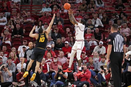Feb 24, 2024; Fayetteville, Arkansas, USA; Arkansas Razorbacks guard Khalif Battle (0) shoots during the first half as Missouri Tigers guard Nick Honor (10) defends at Bud Walton Arena. Mandatory Credit: Nelson Chenault-USA TODAY Sports