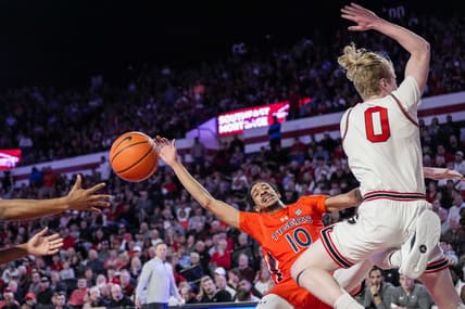 Feb 24, 2024; Athens, Georgia, USA; Auburn Tigers guard Chad Baker-Mazara (10) and Georgia Bulldogs guard Blue Cain (0) collide during the first half at Stegeman Coliseum. Mandatory Credit: Dale Zanine-USA TODAY Sports