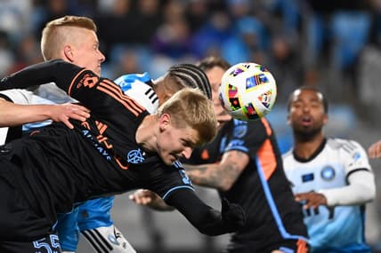 Feb 24, 2024; Charlotte, North Carolina, USA;  New York City midfielder Keaton Parks (55) heads the ball as Charlotte FC Junior Urso (30) defends in the first half at Bank of America Stadium. Mandatory Credit: Bob Donnan-USA TODAY Sports