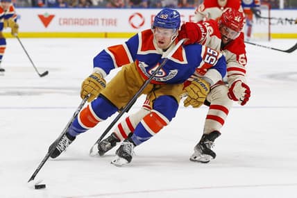 Feb 24, 2024; Edmonton, Alberta, CAN; Edmonton Oilers. forward Dylan Holloway (55) carries the puck around Calgary Flames defensemen Oliver Kylington (58) during the third period at Rogers Place. Mandatory Credit: Perry Nelson-USA TODAY Sports