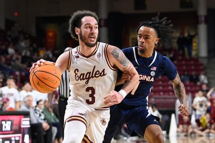 Feb 28, 2024; Chestnut Hill, Massachusetts, USA; Boston College Eagles guard Jaeden Zackery (3) drives the ball  against Virginia Cavaliers guard Dante Harris (1) during the second half at Conte Forum. Mandatory Credit: Eric Canha-USA TODAY Sports