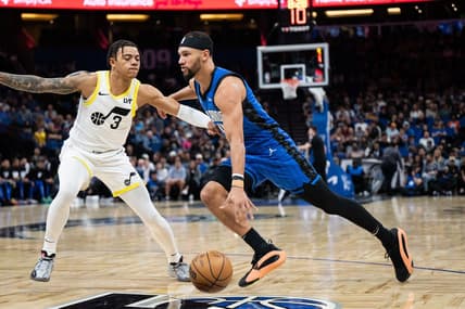Feb 29, 2024; Orlando, Florida, USA; Orlando Magic guard Jalen Suggs (4) dribbles the ball against Utah Jazz guard Keyonte George (3) in the first quarter at Kia Center. Mandatory Credit: Jeremy Reper-USA TODAY Sports
