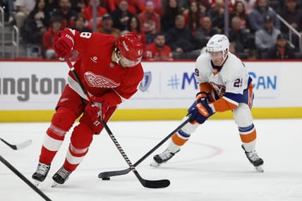 Feb 29, 2024; Detroit, Michigan, USA;  New York Islanders center Brock Nelson (29) skates with the puck defended by Detroit Red Wings defenseman Ben Chiarot (8) in the first period at Little Caesars Arena. Mandatory Credit: Rick Osentoski-USA TODAY Sports
