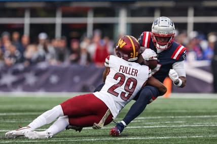Nov 5, 2023; Foxborough, Massachusetts, USA; Washington Commanders cornerback Kendall Fuller (29) tackles New England Patriots receiver JuJu Smith-Schuster (7) during the second half at Gillette Stadium. Mandatory Credit: Paul Rutherford-USA TODAY Sports