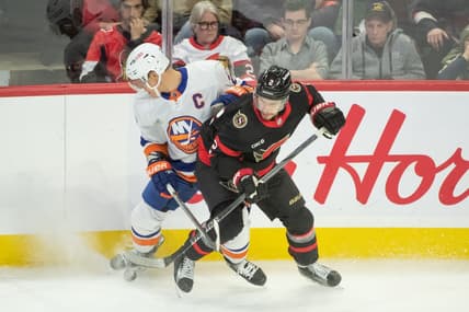 Nov 24 2023; Ottawa, Ontario, CAN; New York Islanders left wing Anders Lee (27) battles with Ottawa Senators defenseman Artem Zub (2) in the third period at the Canadian Tire Centre. Mandatory Credit: Marc DesRosiers-USA TODAY Sports