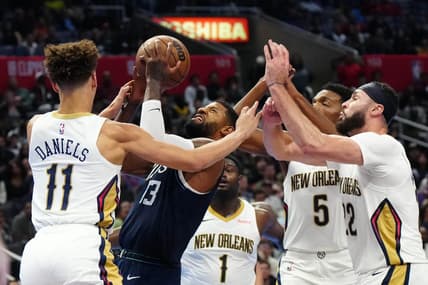Nov 24, 2023; Los Angeles, California, USA; LA Clippers forward Paul George (13) shoots the ball against New Orleans Pelicans guard Dyson Daniels (11) and forwards Zion Williamson (1), Herbert Jones (5) and Larry Nance Jr. (22) in the second half at Crypto.com Arena. Mandatory Credit: Kirby Lee-USA TODAY Sports