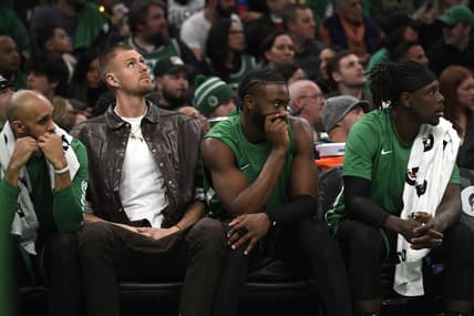 Jan 27, 2024; Boston, Massachusetts, USA;  Boston Celtics center Kristaps Porzingis (8) guard Jaylen Brown (7) and guard Jrue Holiday (4) on the bench during the second half against the LA Clippers at TD Garden. Mandatory Credit: Bob DeChiara-USA TODAY Sports
