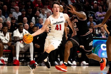 Cincinnati Bearcats guard Simas Lukosius (41) drives on Oklahoma State Cowboys guard Quion Williams (5) in the second half of the NCAA basketball game between Cincinnati Bearcats and Oklahoma State Cowboys at Fifth Third Arena in Cincinnati on Wednesday, Feb. 21, 2024.