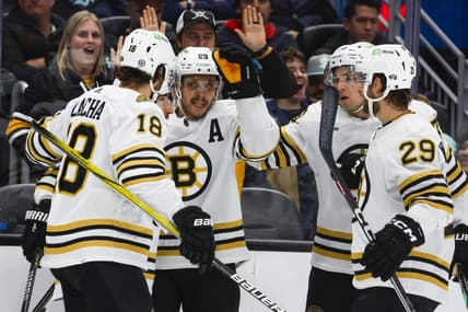 Feb 26, 2024; Seattle, Washington, USA; Boston Bruins right wing David Pastrnak (88, middle) celebrates with teammates   after scoring a goal against the Seattle Kraken during the second period at Climate Pledge Arena. Mandatory Credit: Joe Nicholson-USA TODAY Sports