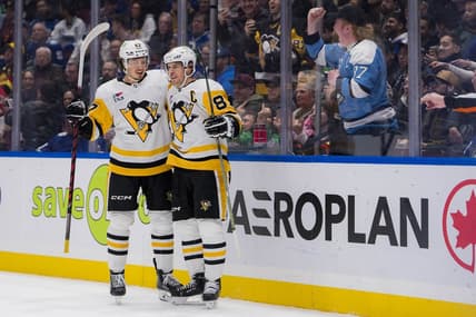 Feb 27, 2024; Vancouver, British Columbia, CAN; Pittsburgh Penguins forward Rickard Rakell (67) and forward Sidney Crosby (87) celebrate Rakell   s second goal of the game against the Vancouver Canucks in the second period at Rogers Arena. Mandatory Credit: Bob Frid-USA TODAY Sports