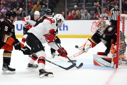 Mar 1, 2024; Anaheim, California, USA; New Jersey Devils center Nico Hischier (13) shoots the puck against Anaheim Ducks goaltender Lukas Dostal (1) during the first period at Honda Center. Mandatory Credit: Kiyoshi Mio-USA TODAY Sports