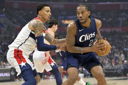Mar 1, 2024; Los Angeles, California, USA; Los Angeles Clippers forward Kawhi Leonard (2) is defended by Washington Wizards forward Kyle Kuzma (33) in the first half at Crypto.com Arena. Mandatory Credit: Jayne Kamin-Oncea-USA TODAY Sports