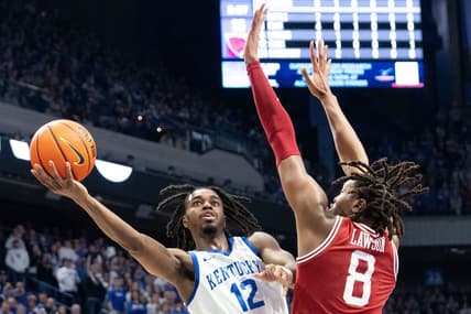 Kentucky Wildcats guard Antonio Reeves (12) goes for a layup against Arkansas Razorbacks forward Chandler Lawson (8) during their game on Saturday, March 2, 2024 at Rupp Arena.