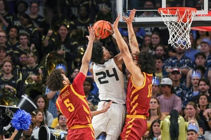 Mar 2, 2024; Orlando, Florida, USA; UCF Knights guard Jaylin Sellers (24) goes to the basket against Iowa State Cyclones guard Curtis Jones (5) and forward Robert Jones (12) during the first half at Addition Financial Arena. Mandatory Credit: Mike Watters-USA TODAY Sports
