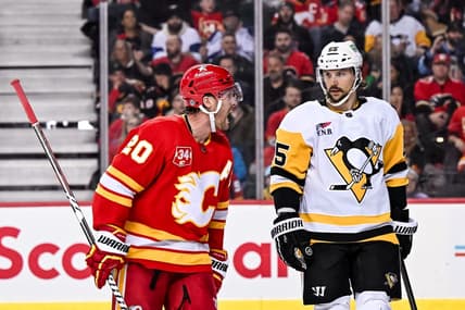 Mar 2, 2024; Calgary, Alberta, CAN; Calgary Flames center Blake Coleman (20) opposes a penalty call while Pittsburgh Penguins defenseman Erik Karlsson (65) looks on during the third period at Scotiabank Saddledome. Mandatory Credit: Brett Holmes-USA TODAY Sports