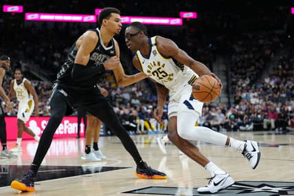 Mar 3, 2024; San Antonio, Texas, USA; Indiana Pacers forward Jalen Smith (25) dribbles against San Antonio Spurs center Victor Wembanyama (1) in the first half at Frost Bank Center. Mandatory Credit: Daniel Dunn-USA TODAY Sports
