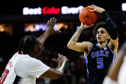 Mar 4, 2024; Raleigh, North Carolina, USA; Duke Blue Devils guard Jeremy Roach (3) shoots the ball past North Carolina State Wolfpack forward DJ Burns Jr. (30) during the first half at PNC Arena. Mandatory Credit: Jaylynn Nash-USA TODAY Sports