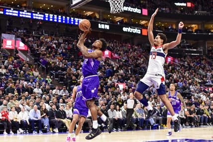 Mar 4, 2024; Salt Lake City, Utah, USA; Utah Jazz guard Collin Sexton (2) takes a shot around Washington Wizards guard Jordan Poole (13) during the second half at the Delta Center. Mandatory Credit: Christopher Creveling-USA TODAY Sports