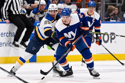 Mar 5, 2024; Elmont, New York, USA;  New York Islanders center Jean-Gabriel Pageau (44) and St. Louis Blues center Jordan Kyrou (25) battle for a loose puck during the first period at UBS Arena. Mandatory Credit: Dennis Schneidler-USA TODAY Sports