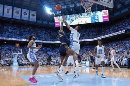 Mar 5, 2024; Chapel Hill, North Carolina, USA; Notre Dame Fighting Irish forward Kebba Njie (14) has his shot blocked by North Carolina Tar Heels forward Armando Bacot (5) during the first half at Dean E. Smith Center. Mandatory Credit: Jim Dedmon-USA TODAY Sports