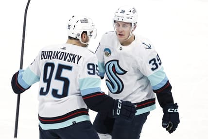 Mar 5, 2024; Winnipeg, Manitoba, CAN; Seattle Kraken left wing Andre Burakovsky (95) celebrates his third period goal with  Seattle Kraken defenseman Ryker Evans (39) against the Winnipeg Jets at Canada Life Centre. Mandatory Credit: James Carey Lauder-USA TODAY Sports
