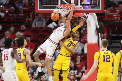 Mar 6, 2024; Fayetteville, Arkansas, USA; Arkansas Razorbacks forward Trevon Brazile (2) dunks the ball in the first half as LSU Tigers guard Jordan Wright (6) defends at Bud Walton Arena. Mandatory Credit: Nelson Chenault-USA TODAY Sports