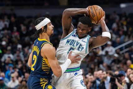 Mar 7, 2024; Indianapolis, Indiana, USA; Minnesota Timberwolves guard Anthony Edwards (5) holds the ball while Indiana Pacers guard Andrew Nembhard (2) defends during the first half at Gainbridge Fieldhouse. Mandatory Credit: Trevor Ruszkowski-USA TODAY Sports