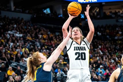 Iowa guard Kate Martin (20) attempts a shot against Michigan guard Lauren Hansen (1) during the Big Ten Tournament semifinals at the Target Center on Saturday, March 9, 2024, in Minneapolis, Minn.