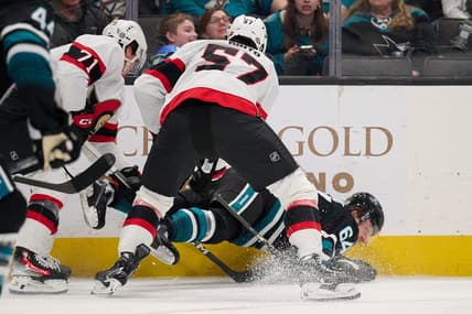 Mar 9, 2024; San Jose, California, USA: Ottawa Senators center Shane Pinto (57) and defenseman Nikolai Knyzhov (71) check San Jose Sharks center Mikael Granlund (64) to the ice during the first period at SAP Center at San Jose. Mandatory Credit: Robert Edwards-USA TODAY Sports