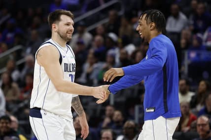 Mar 9, 2024; Detroit, Michigan, USA;  Dallas Mavericks guard Luka Doncic (77) receives congratulations from guard A.J. Lawson (9) in the second half against the Detroit Pistons at Little Caesars Arena. Mandatory Credit: Rick Osentoski-USA TODAY Sports