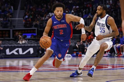 Mar 9, 2024; Detroit, Michigan, USA;  Detroit Pistons guard Cade Cunningham (2) dribbles defended by Dallas Mavericks forward Derrick Jones Jr. (55) in the second half at Little Caesars Arena. Mandatory Credit: Rick Osentoski-USA TODAY Sports