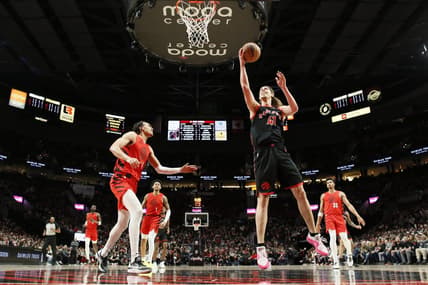Mar 9, 2024; Portland, Oregon, USA; Toronto Raptors power forward Kelly Olynyk (41) shoots the ball as Portland Trail Blazers guard Dalano Banton (5) looks on during the first half at Moda Center. Mandatory Credit: Soobum Im-USA TODAY Sports