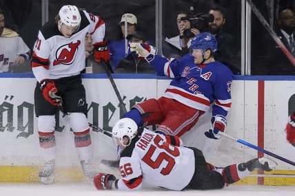 Mar 11, 2024; New York, New York, USA; New Jersey Devils center Dawson Mercer (91) and left wing Erik Haula (56) hit New York Rangers defenseman Adam Fox (23) during the second period at Madison Square Garden. Mandatory Credit: Brad Penner-USA TODAY Sports