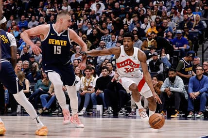 Mar 11, 2024; Denver, Colorado, USA; Toronto Raptors guard Ochai Agbaji (30) drives to the basket against Denver Nuggets center Nikola Jokic (15) in the second quarter at Ball Arena. Mandatory Credit: Isaiah J. Downing-USA TODAY Sports