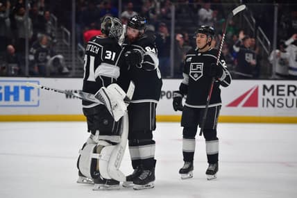 Mar 11, 2024; Los Angeles, California, USA; Los Angeles Kings goaltender David Rittich (31) defenseman Vladislav Gavrikov (84) and defenseman Jordan Spence (21) celebrate the victory against the New York Islanders at Crypto.com Arena. Mandatory Credit: Gary A. Vasquez-USA TODAY Sports