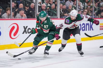 Mar 12, 2024; Saint Paul, Minnesota, USA; Minnesota Wild left wing Kirill Kaprizov (97) skates with the puck against the Arizona Coyotes defenseman J.J. Moser (90) in the second period at Xcel Energy Center. Mandatory Credit: Brad Rempel-USA TODAY Sports