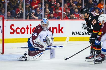 Mar 12, 2024; Calgary, Alberta, CAN; Colorado Avalanche goaltender Justus Annunen (60) makes a save against Calgary Flames center Jonathan Huberdeau (10) during the second period at Scotiabank Saddledome. Mandatory Credit: Sergei Belski-USA TODAY Sports