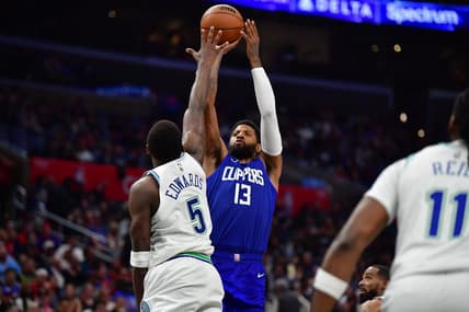 Mar 12, 2024; Los Angeles, California, USA; Los Angeles Clippers forward Paul George (13) shoots against Minnesota Timberwolves guard Anthony Edwards (5) during the second half at Crypto.com Arena. Mandatory Credit: Gary A. Vasquez-USA TODAY Sports