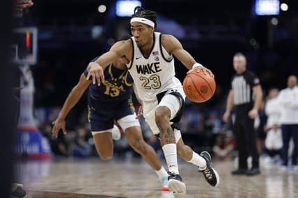 Mar 13, 2024; Washington, D.C., USA; Wake Forest Demon Deacons guard Hunter Sallis (23) drives to the basket past Notre Dame Fighting Irish forward Tae Davis (13) in the second half at Capital One Arena. Mandatory Credit: Geoff Burke-USA TODAY Sports