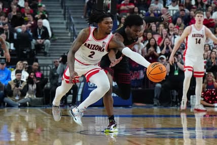 Mar 14, 2024; Las Vegas, NV, USA; Arizona Wildcats guard Caleb Love (2) and Southern California Trojans guard Bronny James (6) battle for the ball in the first half at T-Mobile Arena. Mandatory Credit: Kirby Lee-USA TODAY Sports