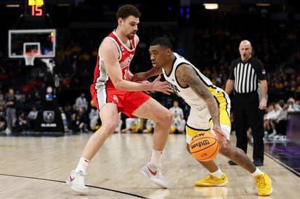 Mar 14, 2024; Minneapolis, MN, USA; Iowa Hawkeyes guard Tony Perkins (11) dribbles around Ohio State Buckeyes forward Jamison Battle (10) during the first half at Target Center. Mandatory Credit: Matt Krohn-USA TODAY Sports