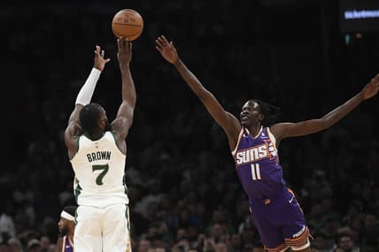 Mar 14, 2024; Boston, Massachusetts, USA;  Boston Celtics guard Jaylen Brown (7) shoots the ball over Phoenix Suns center Bol Bol (11) during the first half at TD Garden. Mandatory Credit: Bob DeChiara-USA TODAY Sports