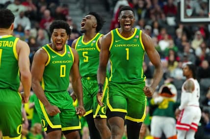 Mar 15, 2024; Las Vegas, NV, USA; Oregon Ducks center N'Faly Dante (1) celebrates with Oregon Ducks guard Kario Oquendo (0), and Oregon Ducks guard Jermaine Couisnard (5) after making a play against the Arizona Wildcats during the second half at T-Mobile Arena. Mandatory Credit: Stephen R. Sylvanie-USA TODAY Sports