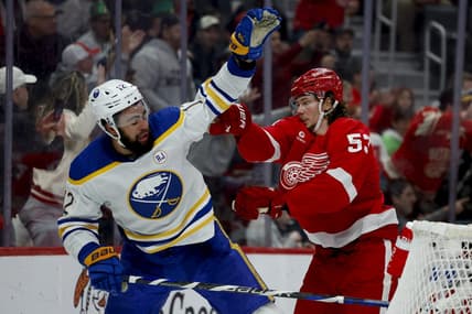 Mar 16, 2024; Detroit, Michigan, USA;  Detroit Red Wings defenseman Moritz Seider (53) shoves Buffalo Sabres left wing Jordan Greenway (12) in the third period at Little Caesars Arena. Mandatory Credit: Rick Osentoski-USA TODAY Sports