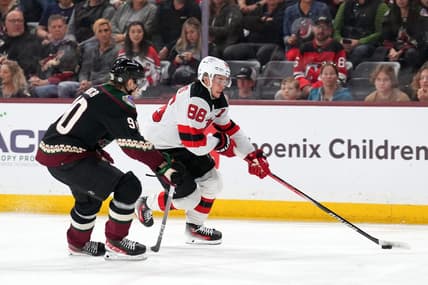 Mar 16, 2024; Tempe, Arizona, USA; New Jersey Devils center Jack Hughes (86) skates against Arizona Coyotes defenseman J.J. Moser (90) during the third period at Mullett Arena. Mandatory Credit: Joe Camporeale-USA TODAY Sports