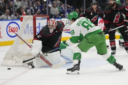 Mar 16, 2024; Toronto, Ontario, CAN; Toronto Maple Leafs forward Nicholas Robertson (89) and Carolina Hurricanes goaltender Pyotr Kochetkov (52) battle for the puck during the first period at Scotiabank Arena. Mandatory Credit: John E. Sokolowski-USA TODAY Sports